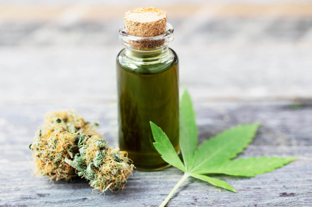 Bottle of cannabis oil with cannabis bud